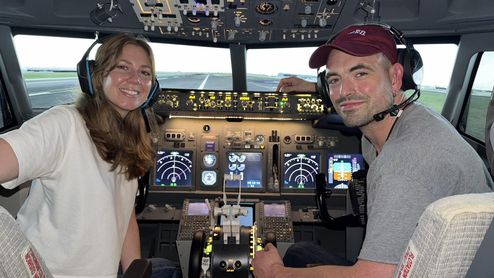 A flight simulator session with an instructor beside the pilot